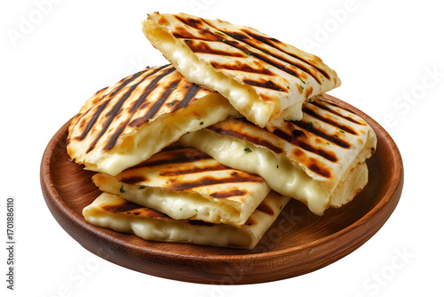 Grilled cheese quesadilla or Cachapas sweet corn pancakes with melted white cheese stacked on wooden plate, isolated on white transparent background, concept of Venezuela street fast food