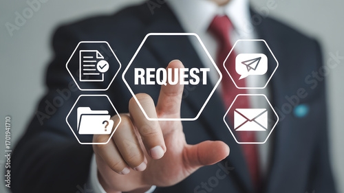 Digital Request: A businessman in a suit, elegantly points at a virtual button, an innovative depiction of digital requests and communication through modern technology.
