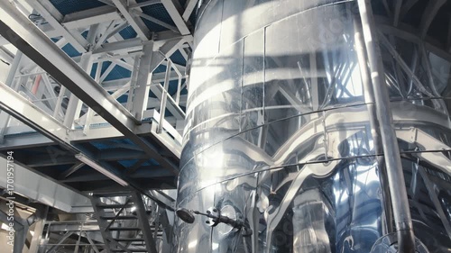 A clean aluminum shiny liquid barrel at the factory. plated vat in production.