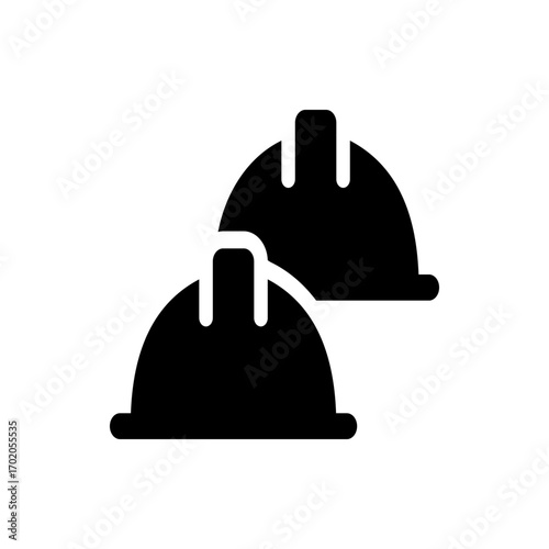 Two black construction helmets stacked slightly offset providing safety and protection for workers on site