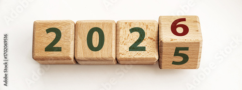 Wooden blocks display years 2025 and 2026, symbolizing end of one year and start of another, inspiring thoughts of change and new opportunities for growth.