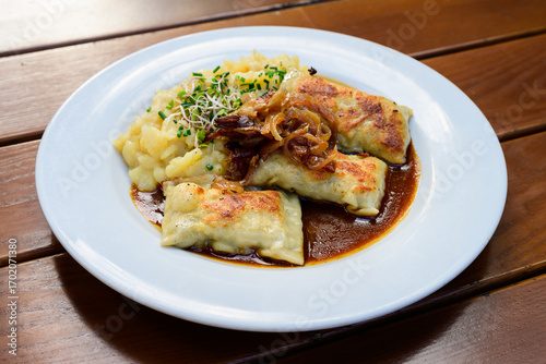 Maultaschen German Meat Filled Dumplings or Pasta with Gravy Sauce and Potato Salad