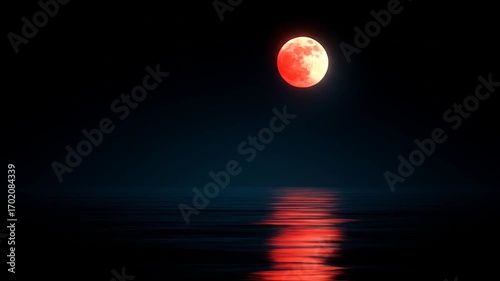 A vibrant, blood-red moon hangs over a still body of water, casting a reflection.