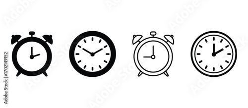 Collection of four vintage alarm clocks in black and white showing different times