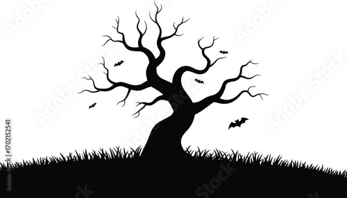 Black silhouette of a gnarled tree with bats and grass