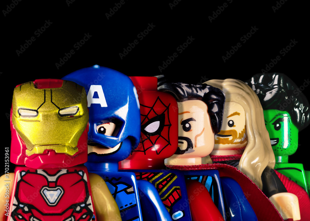 Naklejka premium LEGO Marvel Avengers stand behind each other. Marvel Iron Man, Captain America, Spider-Man, Doctor Strange, Thor, and Hulk faces on a black background