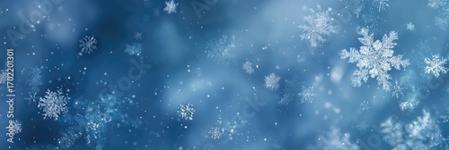White and silver snowflakes are spread out across the blue background