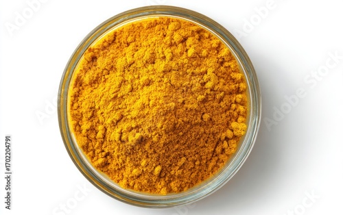 Bright yellow spice powder in small glass bowl