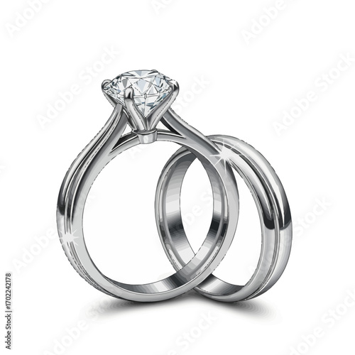 A close-up studio shot of a sparkling diamond engagement ring and a plain wedding band, both made of white gold or platinum, set against a pure white background.