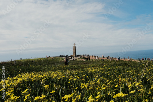 Scenic landscape of Cabo da Roca lighthouse with blue sky dramatic cliffs Atlantic Ocean rugged coastline in Sintra Portugal popular travel destination viewpoint with natural vegetation. High quality