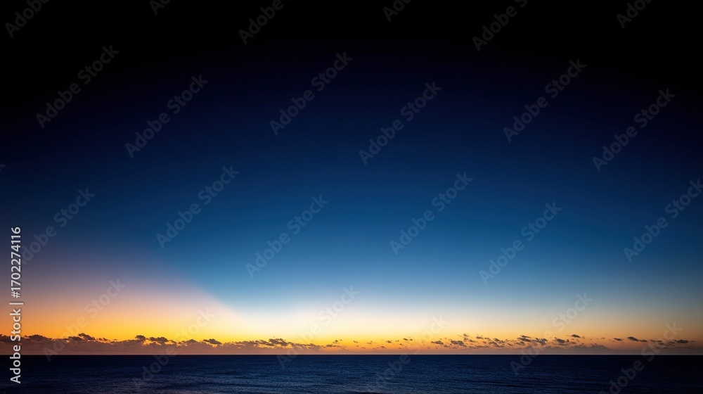 Fototapeta premium The beautiful sunset on the ocean horizon provides ample blank space for text or design, making it perfect for travel, vacation, or nature themes.