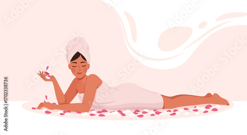 Woman enjoying spa treatment lying down surrounded by rose petals in a wellness center