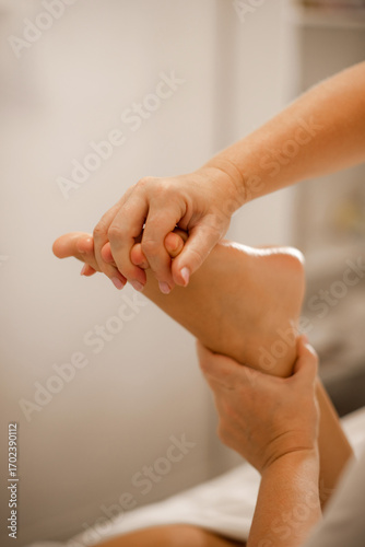 masseuse doing toe massage in spa. Professional foot massage close up