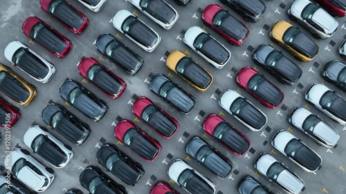 Aerial view car for sale stock lot row, Cars dealership inventory distribution automobile and automotive business, New cars parking for sale automobile automotive industry business.
