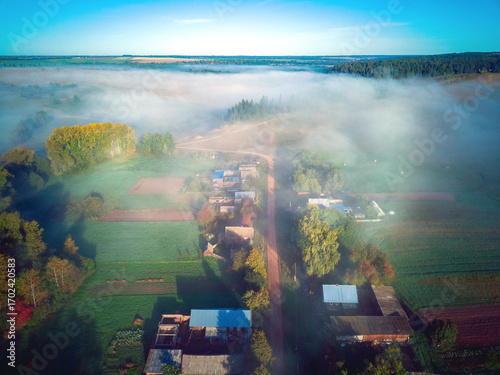Aerial view landscape on foggy morning in countryside with lake and forest

