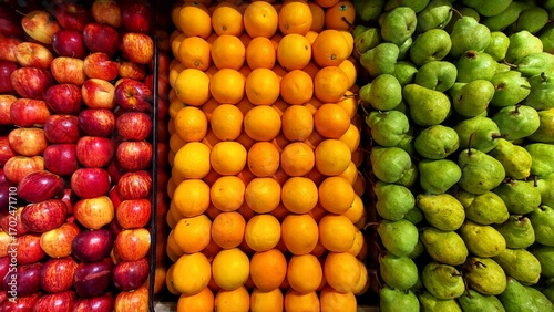 This is a vibrant and colorful close-up shot of a display of fresh fruit. The image is divided into three distinct vertical sections. 