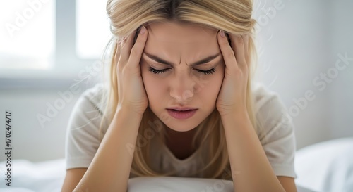 Woman experiencing intense headache pain.