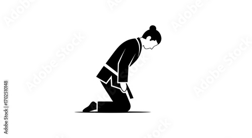 Silhouette of a Person Kneeling in a Bowing Position.