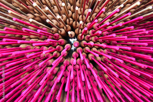 Extreme close-up of vibrantly pink traditional incense sticks arranged in a circular pattern in Xianxi Township, Changhua County, Taiwan, highlighting texture and color.