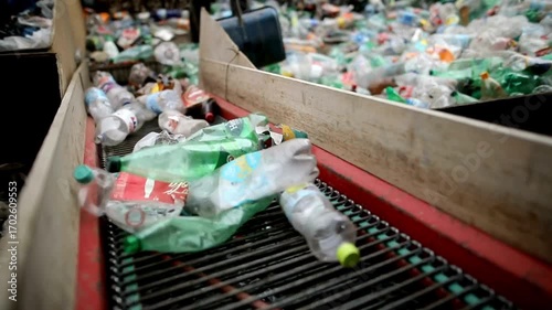 Plastic bottle recycling process at plant conveyor belt sorting system.