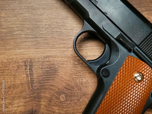 Airsoft gun with wooden details. Though only an airsoft replica, the photo highlights the weapon’s beauty while evoking power and danger.