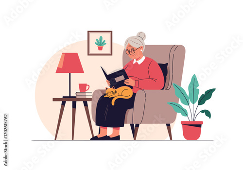 Elderly woman enjoys reading a book while relaxing in a comfortable armchair with her cat on her lap