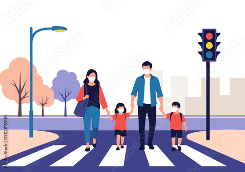Family wearing masks crossing a street at a crosswalk with a traffic light showing red