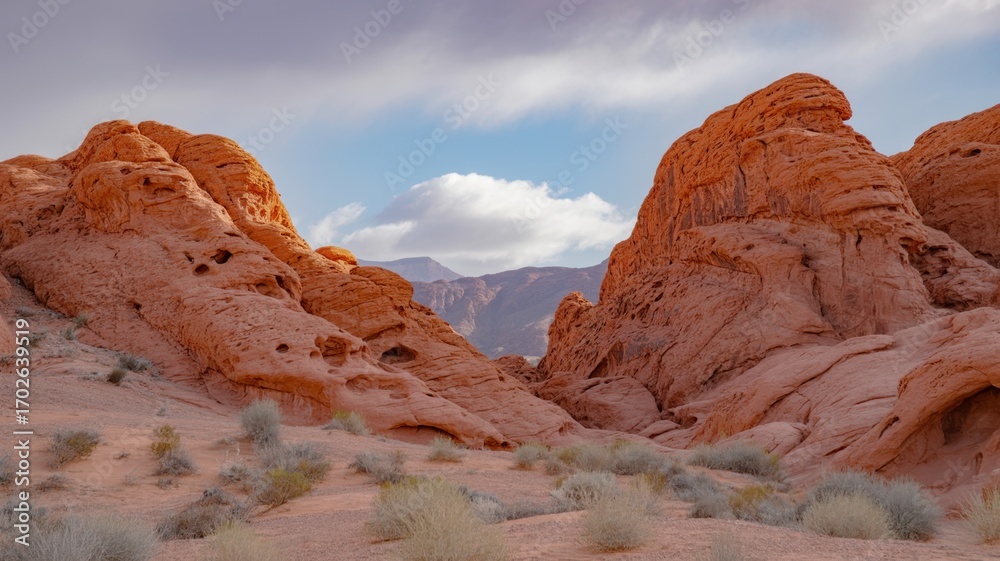 Fototapeta premium Ai generated image of vibrant red sandstone rock formations and arid desert landscape under a partly cloudy sky in valley of fire state park, nevada