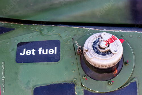 Jet fuel cap closeup on the body of french military helicopter Gazelle SA 341 and Jet Fuel label on its right