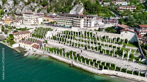Limonaia - the lemon terraces of Limone sul Garda, Italy. Aerial 4K video footage of old lemon house in lake Garda. Drone view of lemon grove