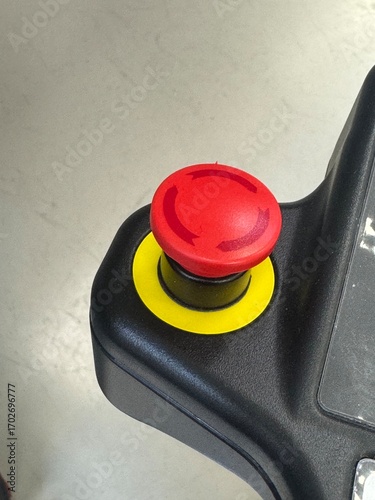 Red emergency stop button on industrial machinery.