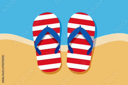Striped flip flops on a sandy beach with blue sky