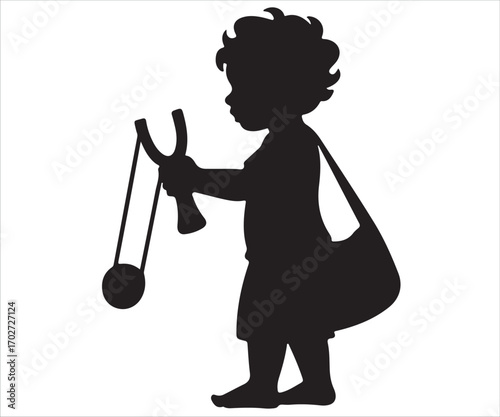 Silhouette of little boy holding slingshot, symbol of childhood play and mischief