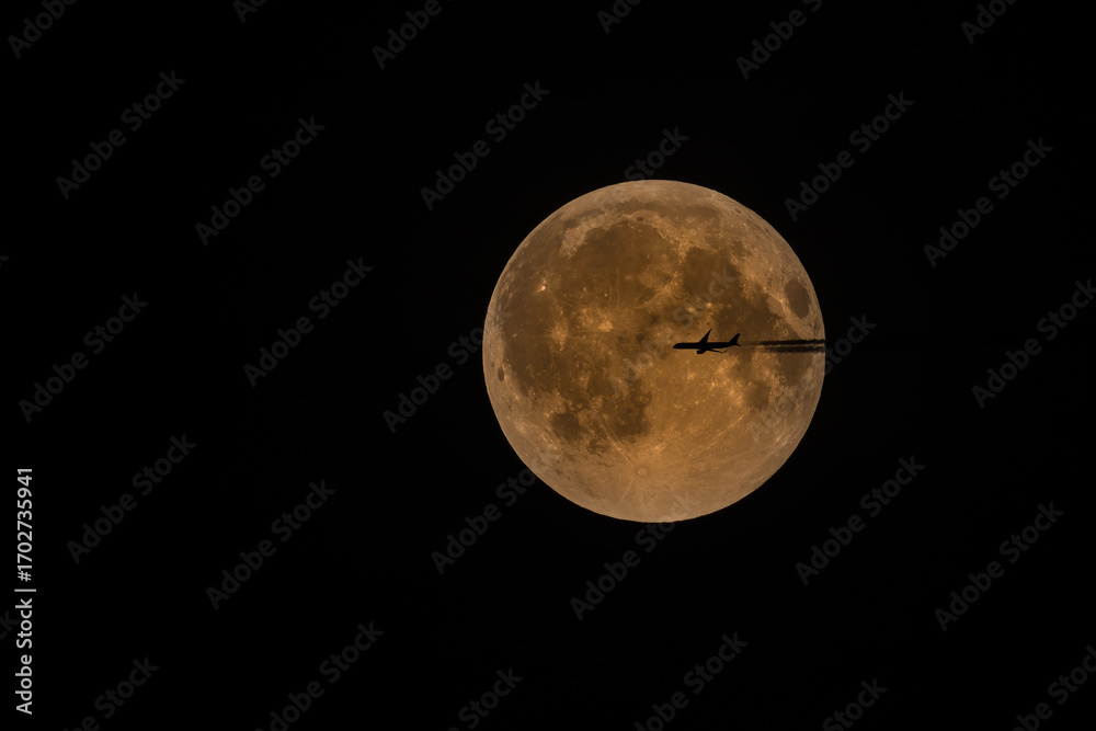 Obraz premium Vollmond vom September 2025, nach der Mondfinsternis mit einem vorbeifliegendem Flugzeug als Silhouette.