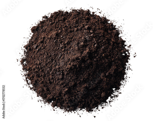 A dark, rich mound of soil,?perfectly?circular,?isolated against a black background