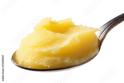 Creamy, golden-yellow ghee on a spoon