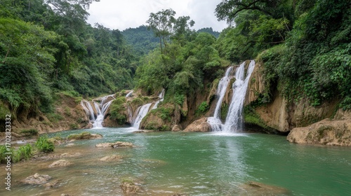 Tranquil Waterfall Surrounded by Lush Greenery in Nature Setting