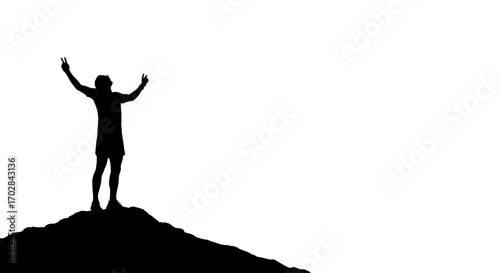 Silhouette of victorious male figure raising arms in celebration on a peak