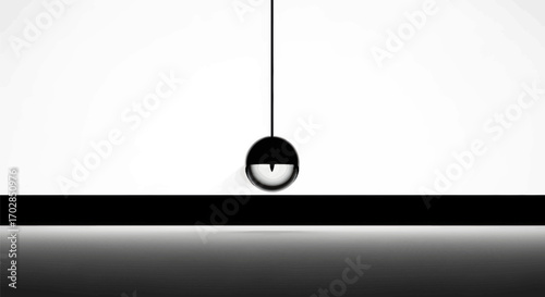 Minimalist composition featuring a suspended sphere in monochromatic tones creating a sense of