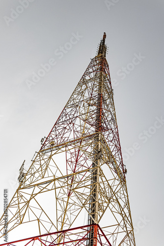 Tall communication tower against clear sky, ideal for telecom, technology, and infrastructure projects