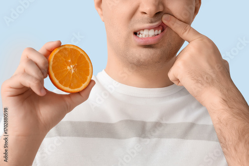 Young man with orange suffe...