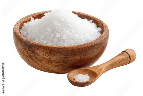 Wooden bowl filled with white salt crystals, a small wooden spoon holding a bit of salt beside it