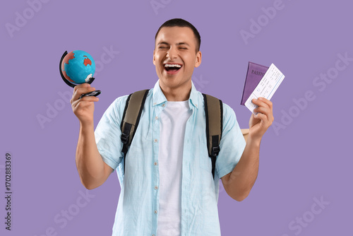 Happy male tourist with glo...