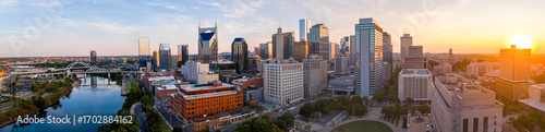 Panoramic view of Nashville skyline at sunset with river, skyscrapers, and city landmarks