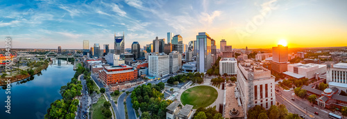Panoramic view of Nashville skyline at sunset with river, skyscrapers, and city landmarks