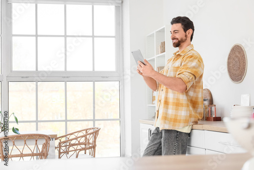 Handsome man using tablet c...