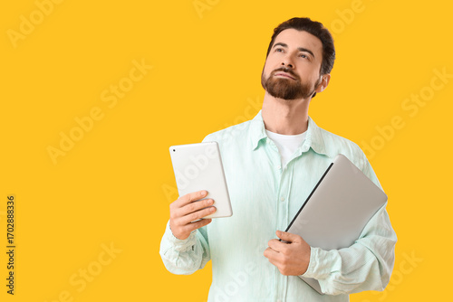 Handsome man with laptop an...
