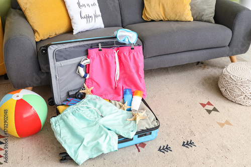Open suitcase with men's sw...