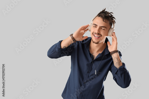 Happy Young Man Listening t...