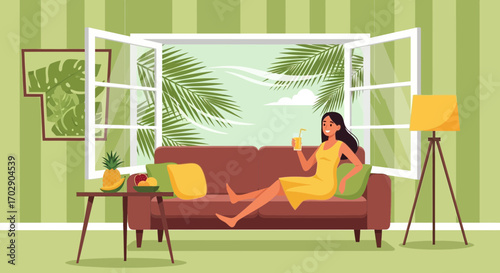 Woman enjoying a tropical drink on the sofa while gazing out at a palm tree view